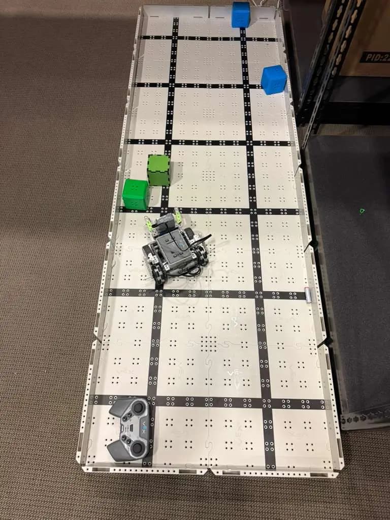 The robotics arena mat with a robot and controller